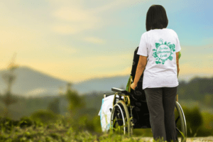 A woman in a wheelchair looking at the mountains.