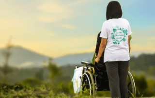 A woman in a wheelchair looking at the mountains.