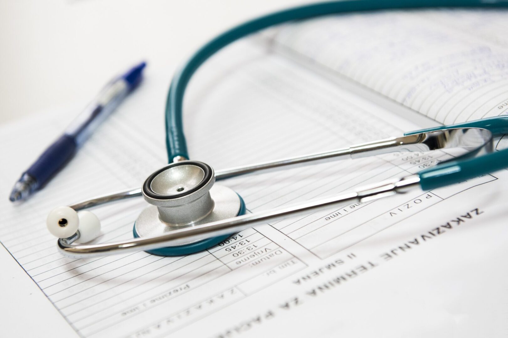 Stethoscope and pen on medical forms