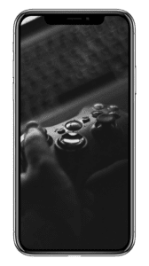 A black and white photo of a person holding a game controller on an iphone.