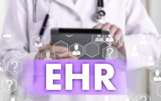 A doctor holding a tablet with ehr management software.