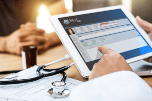 A person is using a tablet to access an EHR.